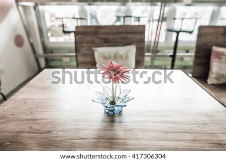 Little Gerbera flower on wooden table, Thailand