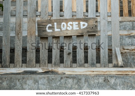 Closed sign on old wooden fence