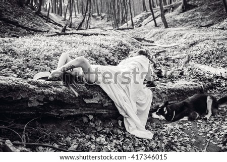 young girl with dog lying on the nature and resting
