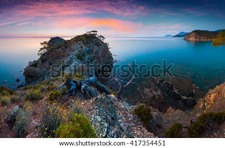 Picturesque Mediterranean seascape in Turkey. Colorful sunrise in a small bay near the Tekirova village, District of Kemer, Antalya Province. Artistic style post processed photo.