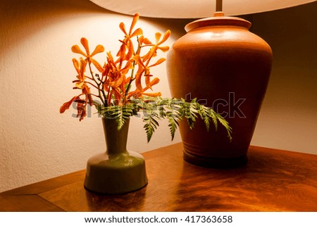 Vintage table lamp  light on wooden table with flowers .