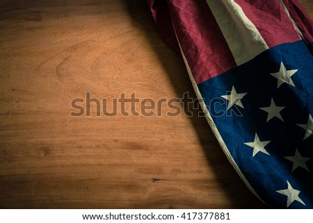 Old American flag on wood background for Memorial Day or 4th of July or Dependence Day
