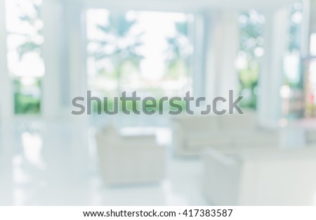 blur image of living room with table and sofa for background usage.