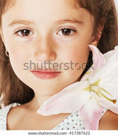 little cute beauty girl isolated on white background holding flower lily in her hair, close up adorable kid