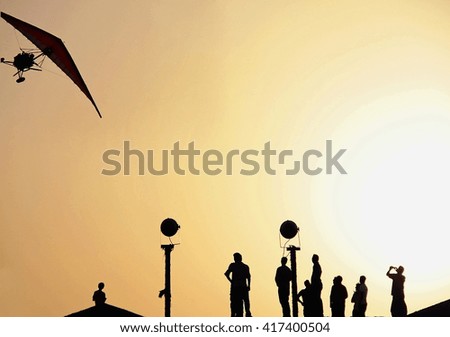 Silhouettes of people in the desert at sunset, hiking and walking, summer heat, a flight to aeroplane