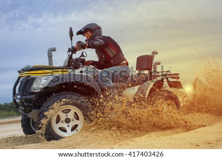 Racing ATV is sand.  Royalty-Free Stock Photo #417403426