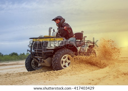 Racing ATV is sand.  Royalty-Free Stock Photo #417403429