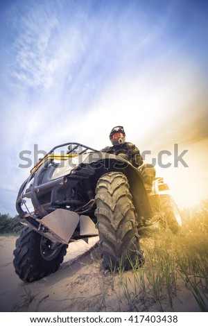 Racing ATV is sand.  Royalty-Free Stock Photo #417403438