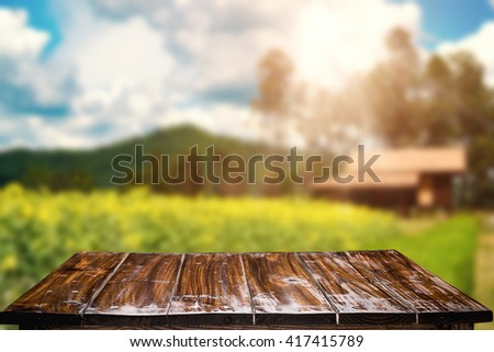 Desk space platform and blurred background of landscape with blue sky. For product display montage.