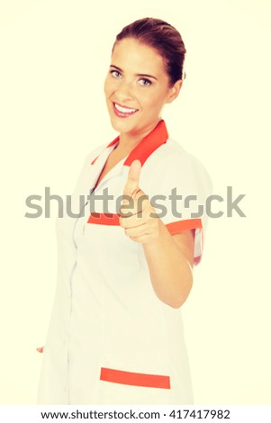 Young smile female doctor or nurse with thumbs up