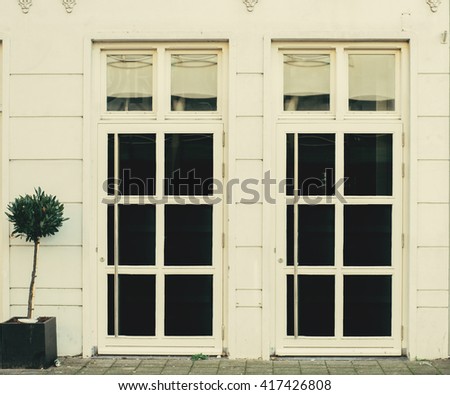 Huge warm white facade windows doors entrance to cafe coffeeshop restaurant workshop warehouse. 