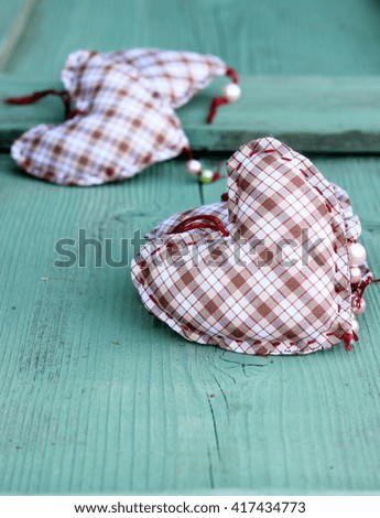 Card with handmade textile hearts on green wooden background. Concept for valentines day or any love theme