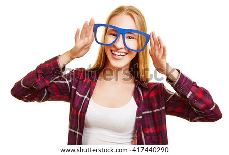 Happy blonde woman holding fake glasses in front of her eyes