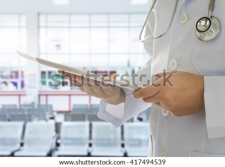 Doctor using a digital tablet computer in hospital. Technology and Medical Concept.