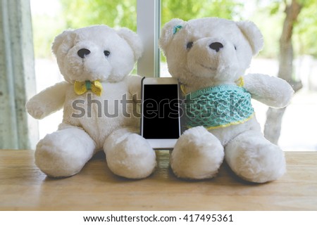 Bear dolls with blank smartphone