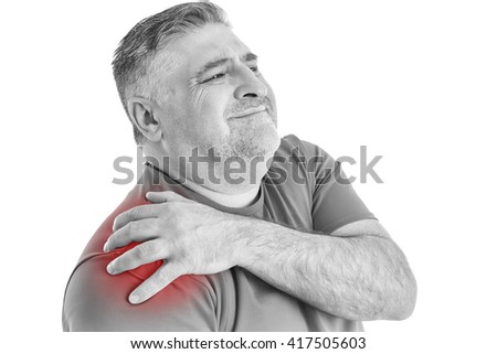 Man holding sore shoulder with hand touching or massaging in workout stress body pain and health problem isolated on white background. Black & white picture.

