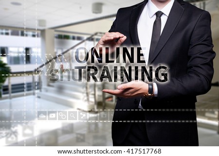 Glowing text "Online Training" in the hands of a businessman. Business concept. Internet concept.