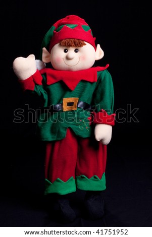 Holiday elf boy waving with black background