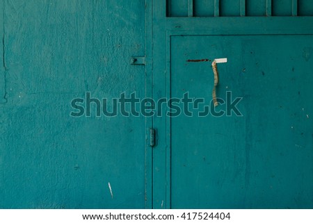 petrol blue wall and door with paper strip Royalty-Free Stock Photo #417524404