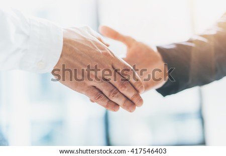 Business partnership meeting. Photo businessmans handshake. Successful businessmen handshaking after good deal. Horizontal, blurred background, film effect. Royalty-Free Stock Photo #417546403