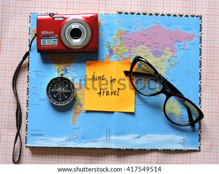 Map of the world. Planning a trip or adventure. Travel planning dreams. Map of the world. Travel, tourism and vacation concept background. Stylish notebook, map and magnifier. Flat lay. Travel agency.