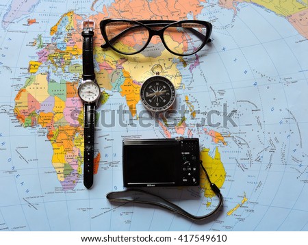 Map of the world. Planning a trip or adventure. Travel planning dreams. Map of the world. Travel, tourism and vacation concept background. Stylish notebook, map and magnifier. Flat lay. Travel agency.