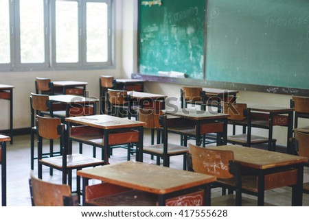 Wooden Thai school desk and chairs, "I am here"in Thai was written on the table Royalty-Free Stock Photo #417555628
