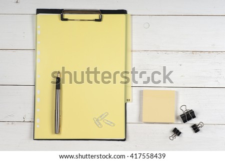 Business blank, notepad,  and pen at office desk table top view. Corporate stationery branding mock-up.  Copy space for text.