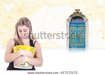 Sad girl with empty popcorn box