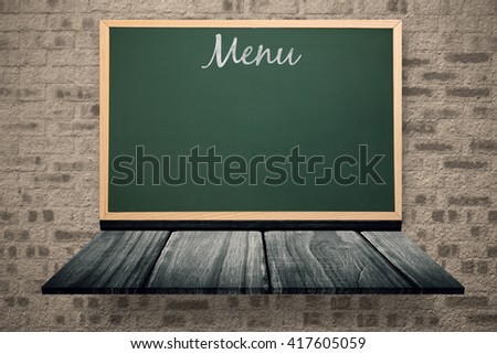 Menu message against blackboard on a wooden shelf