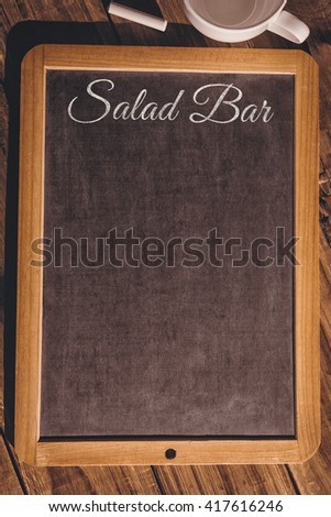 Salad bar message against chalkboard on desk