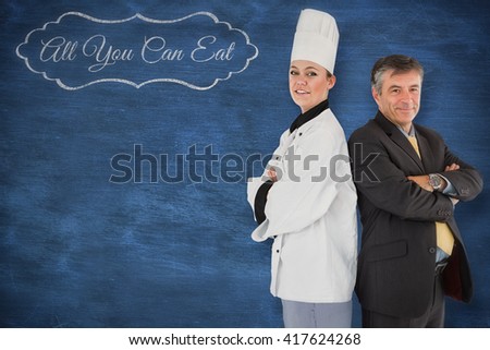 A cook posing with a businessman against blue chalkboard
