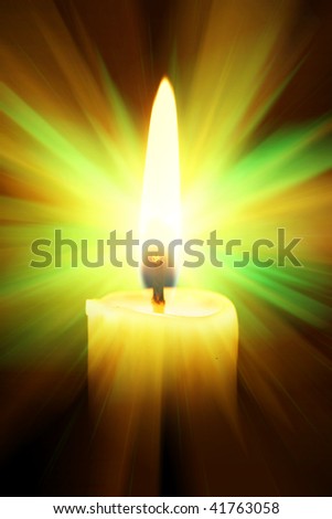 Single burning burning candle over a black background