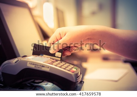 Moment of payment with a credit card through terminal.monochrome Royalty-Free Stock Photo #417659578