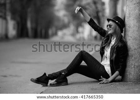 Photo of a young beautiful woman on the city street