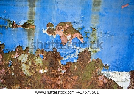 Old and damaged, cracked paint on tin surfaces.