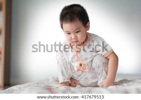 little asian boy playing digital tablet, early learning
