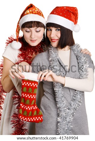 Two girls in christmas hats taking out presents, white background