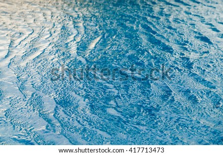 Blue swimming pool rippled water detail, abstract background