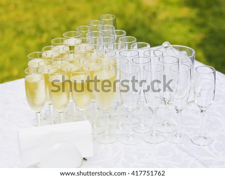 Wedding banquet outdoors. Wedding ceremony.Glasses of champagne. are poured champagne