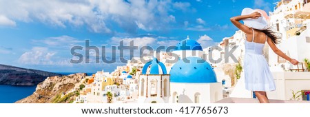 Europe tourist travel woman panorama banner from Oia, Santorini, Greece. Happy young woman looking at famous blue dome church landmark destination. Beautiful girl visiting the Greek islands.