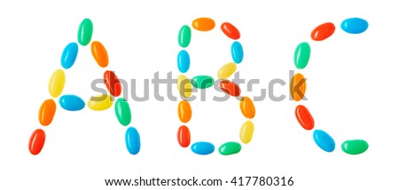 ABC lettering made of multicolored candies isolated on white background