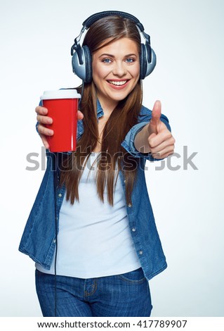 Beautiful girl listening music with coffee glass. Smiling young woman. 