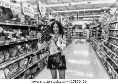 Woman at supermarket choosing Valentine's present.