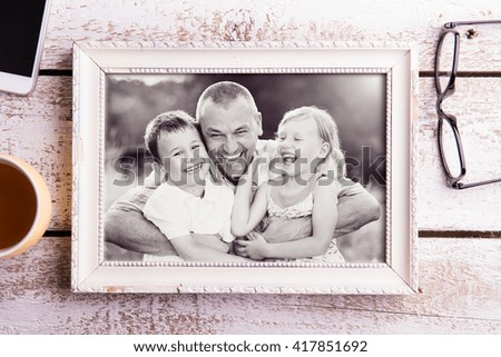 Fathers day composition. Picture of father with children in fram