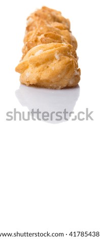 Choux pastry sprinkled with sugar over white background