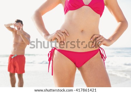 Happy couple posing on the beach on a sunny day
