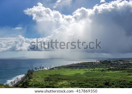 Rainstorms drifting over Maui landscape 