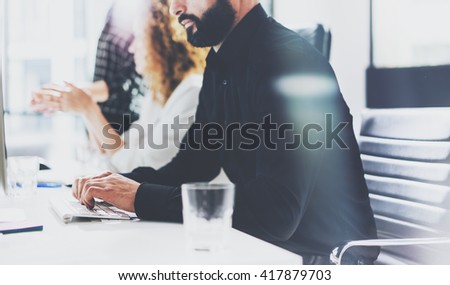 Business concept. Bearded businessman working investment startup project modern office.Typing text document contemporary laptop. Film effect. Blurred background, horizontal. 