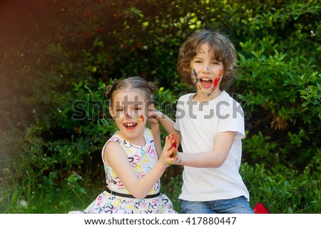 Children soiled with paint, having fun and looking into the camera. Child has fun painting / drawing. Children's creativity. Art for baby. Emotions. Children playing. Delight.